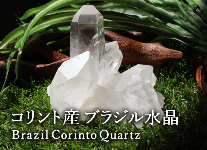 コリント産 ブラジル水晶 クラスター 原石（天然石 パワーストーン 置物）を草の前に置いて撮影